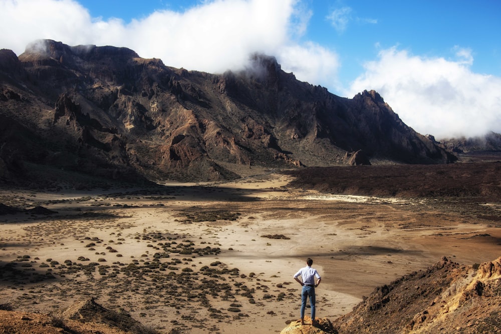 a man standing on a rocky hillside