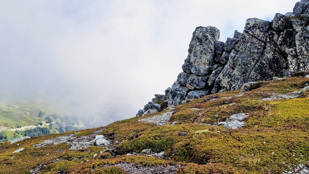 a rocky mountain with a stream running through it