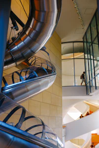 Architectural 3D rendering of a modern indoor playground integrated within a commercial building space.