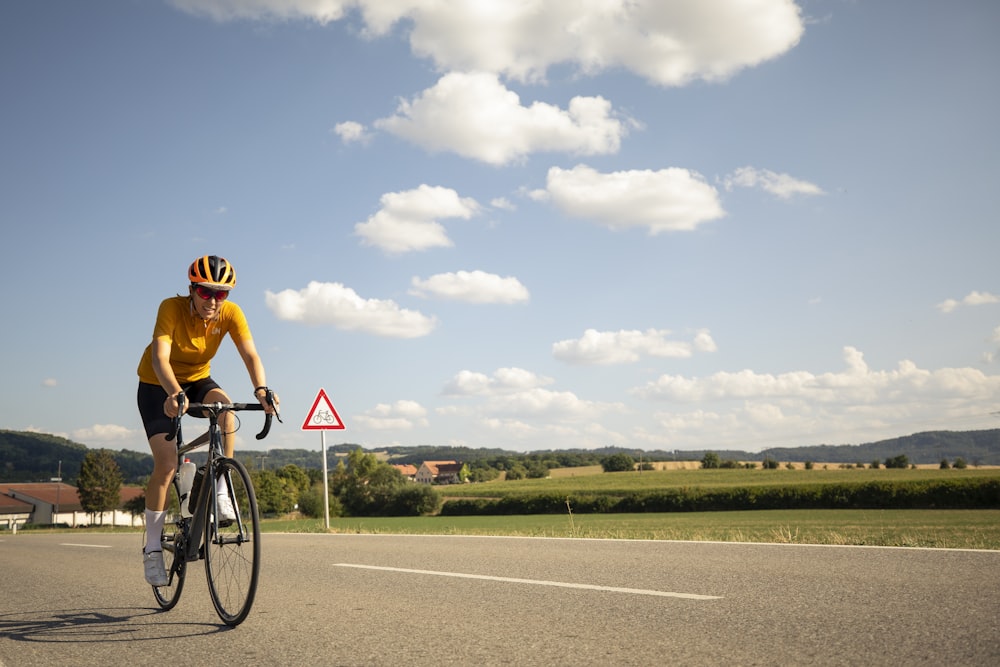 a man riding a bicycle on a road