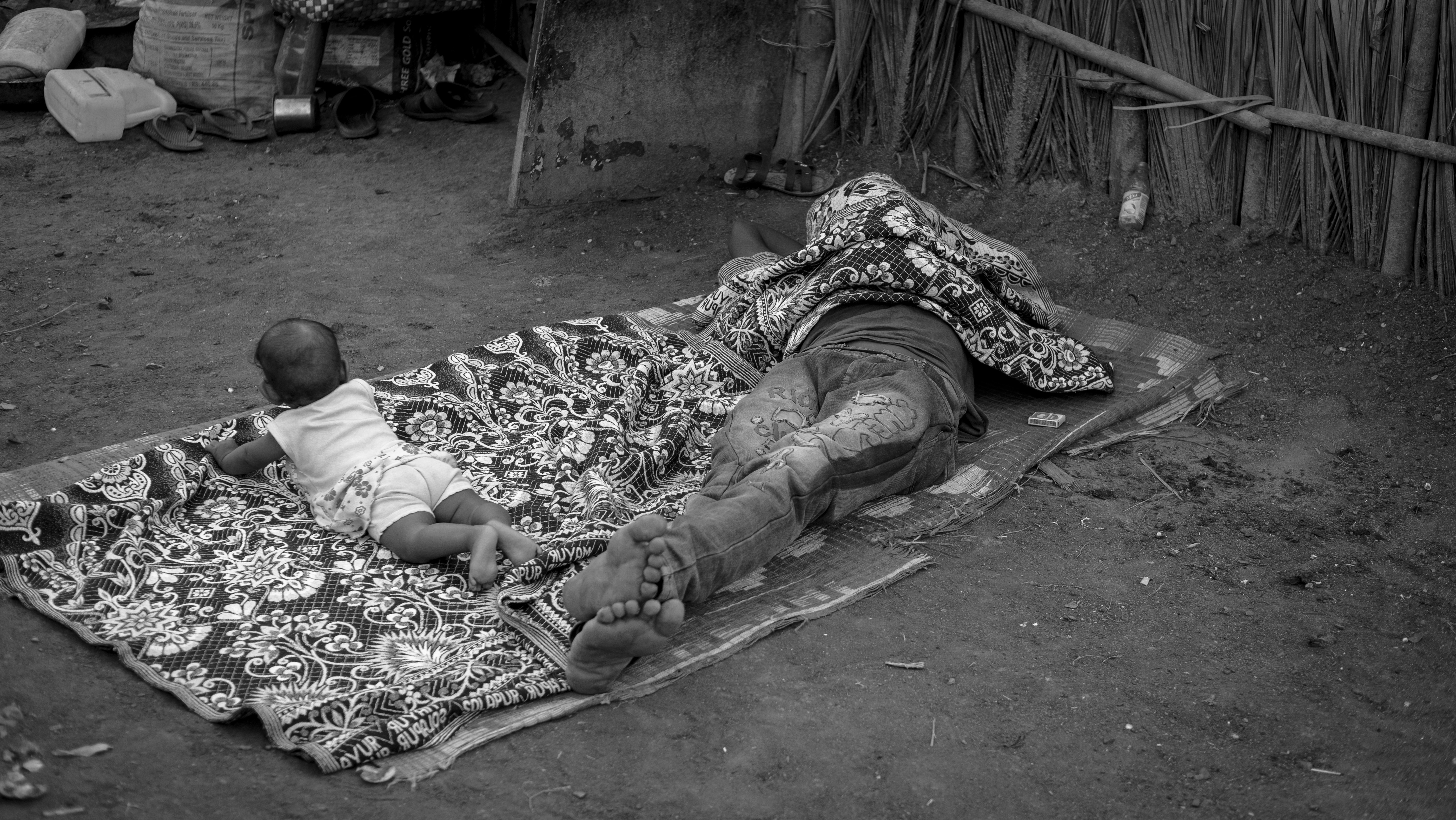 A person and a child lying on a blanket on the ground photo Free Innocent Image on Unsplash