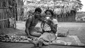 a man and woman holding a baby