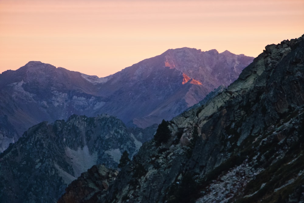 a mountain range with a plane flying over it