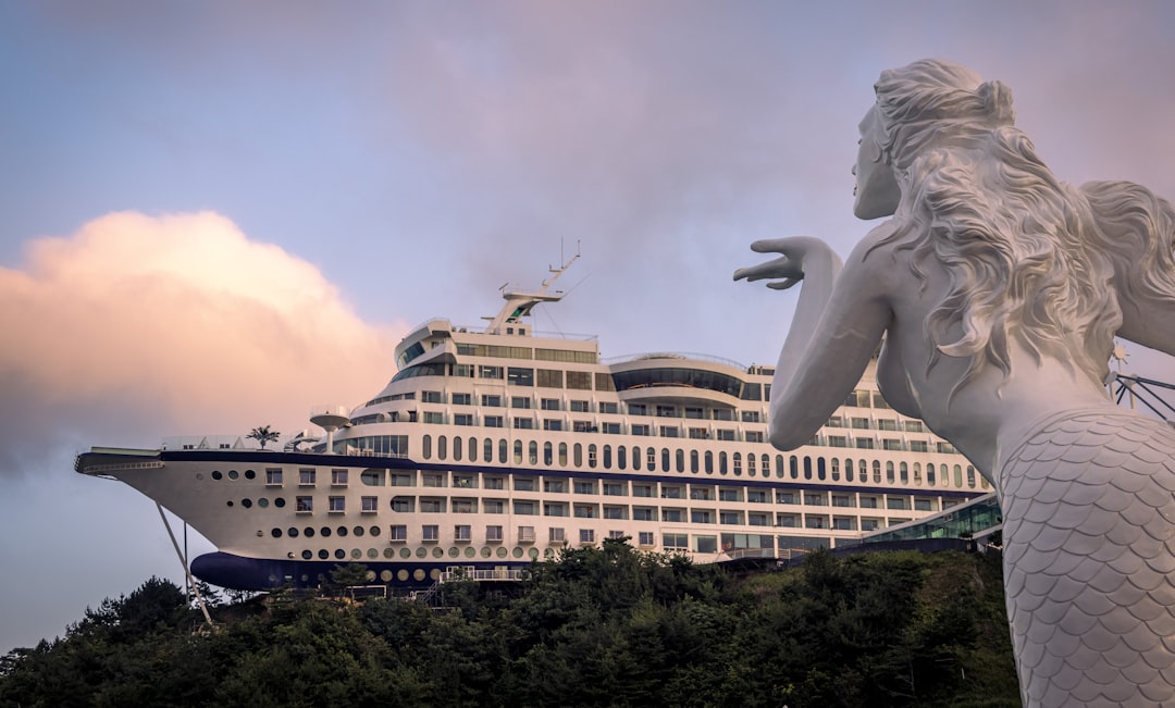 a statue of a person with a large building in the background,