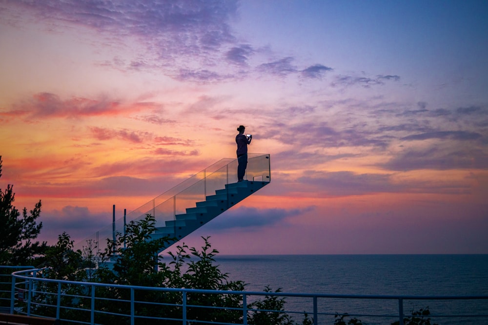 a person standing on a bridge