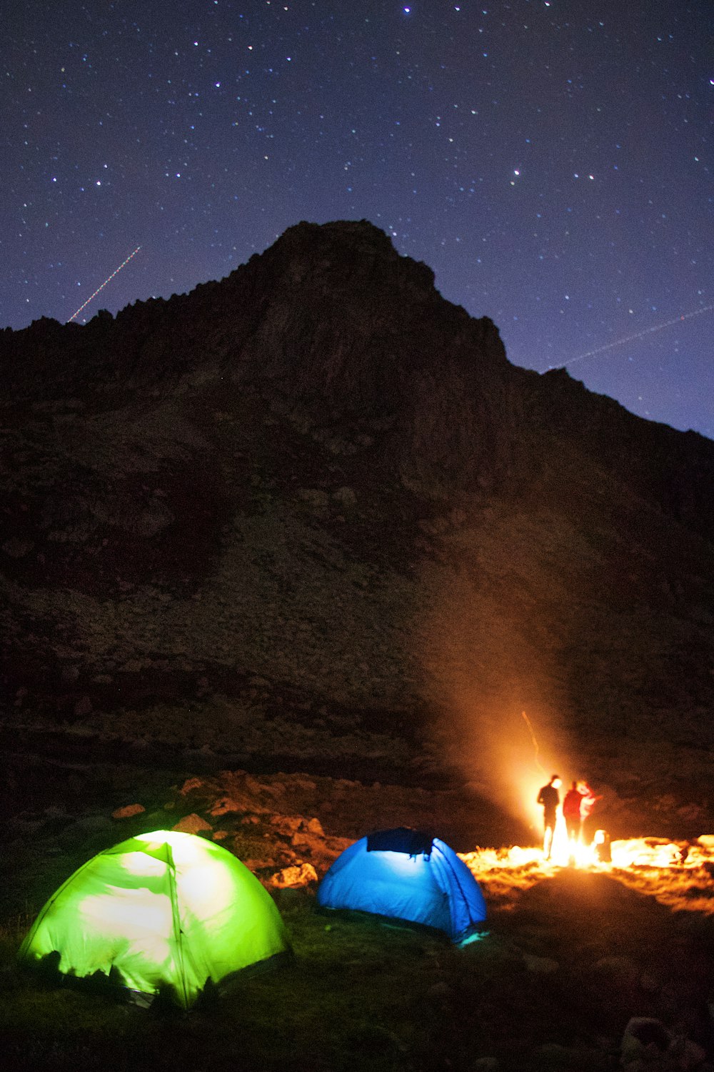 a person in a dark room with a mountain in the background