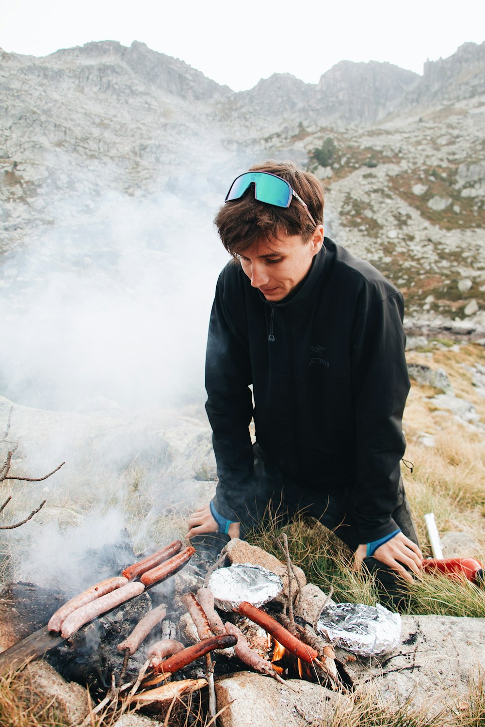 a man sitting on top of a mountain