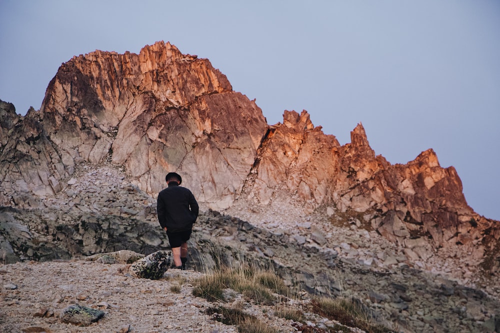 a man standing on a rocky hill