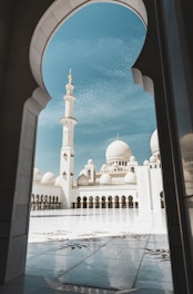 Front view of Shah Jalal Masjid with its serene courtyard under a clear sky.