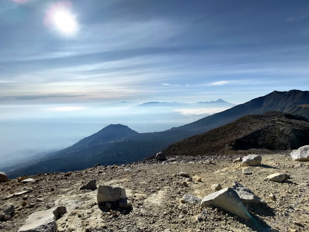 a rocky area with mountains in the background