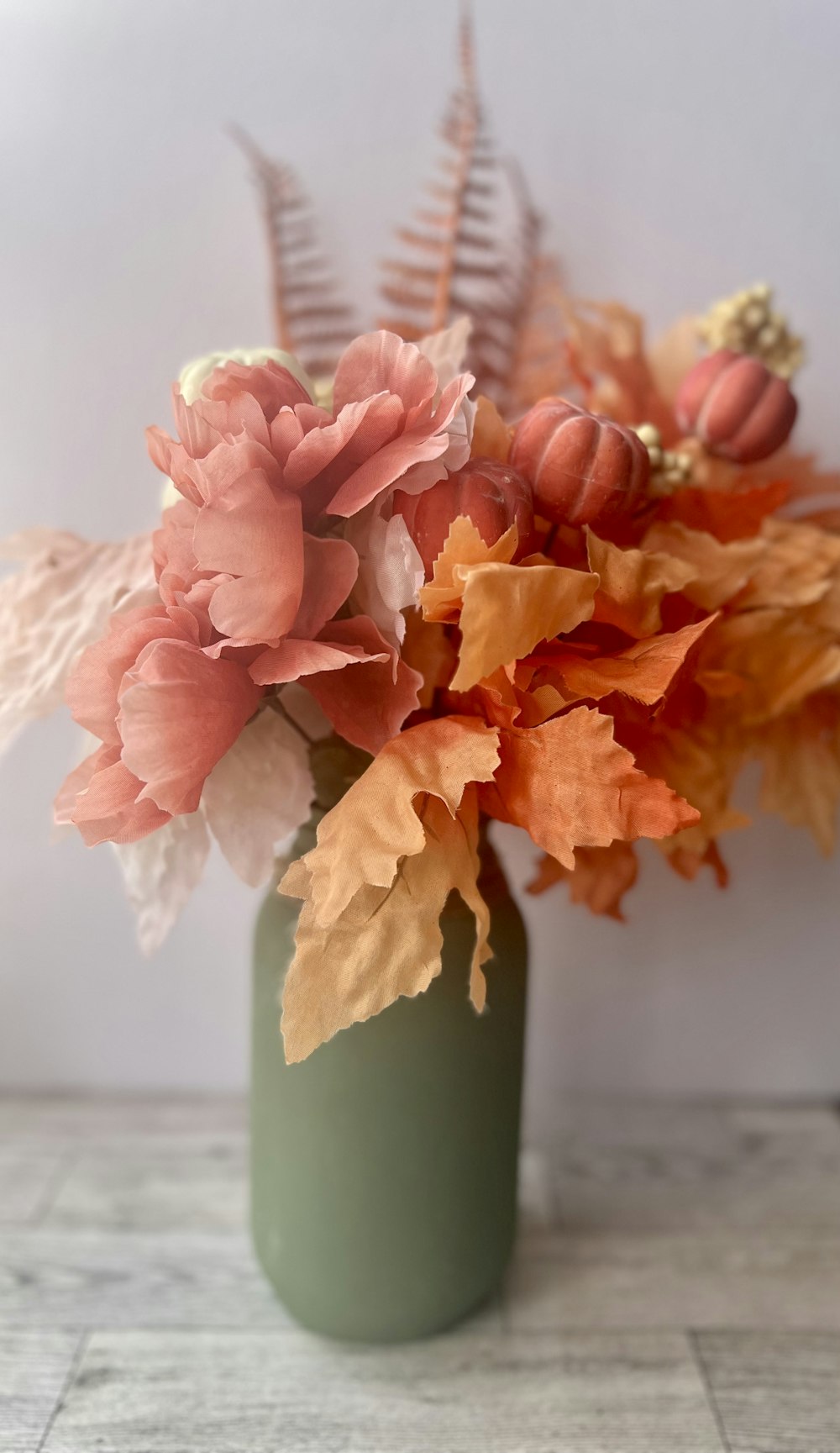 a vase with orange flowers