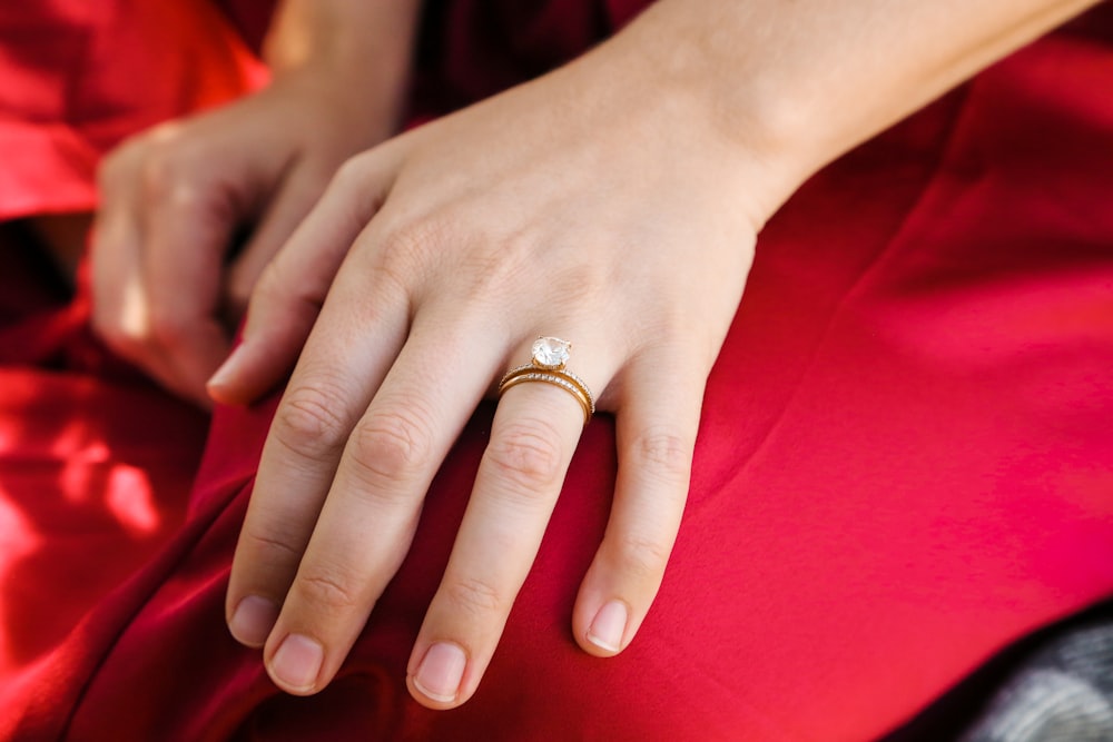 a person's hands with a ring on their finger