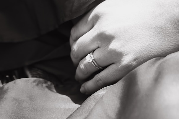 An intimate close-up of a wedding ring resting on a soft fabric.