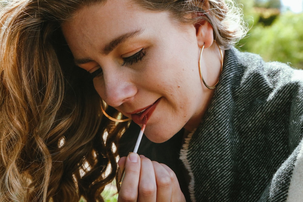 a woman with a cigarette in her mouth