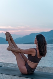 a person sitting on a ledge overlooking the ocean