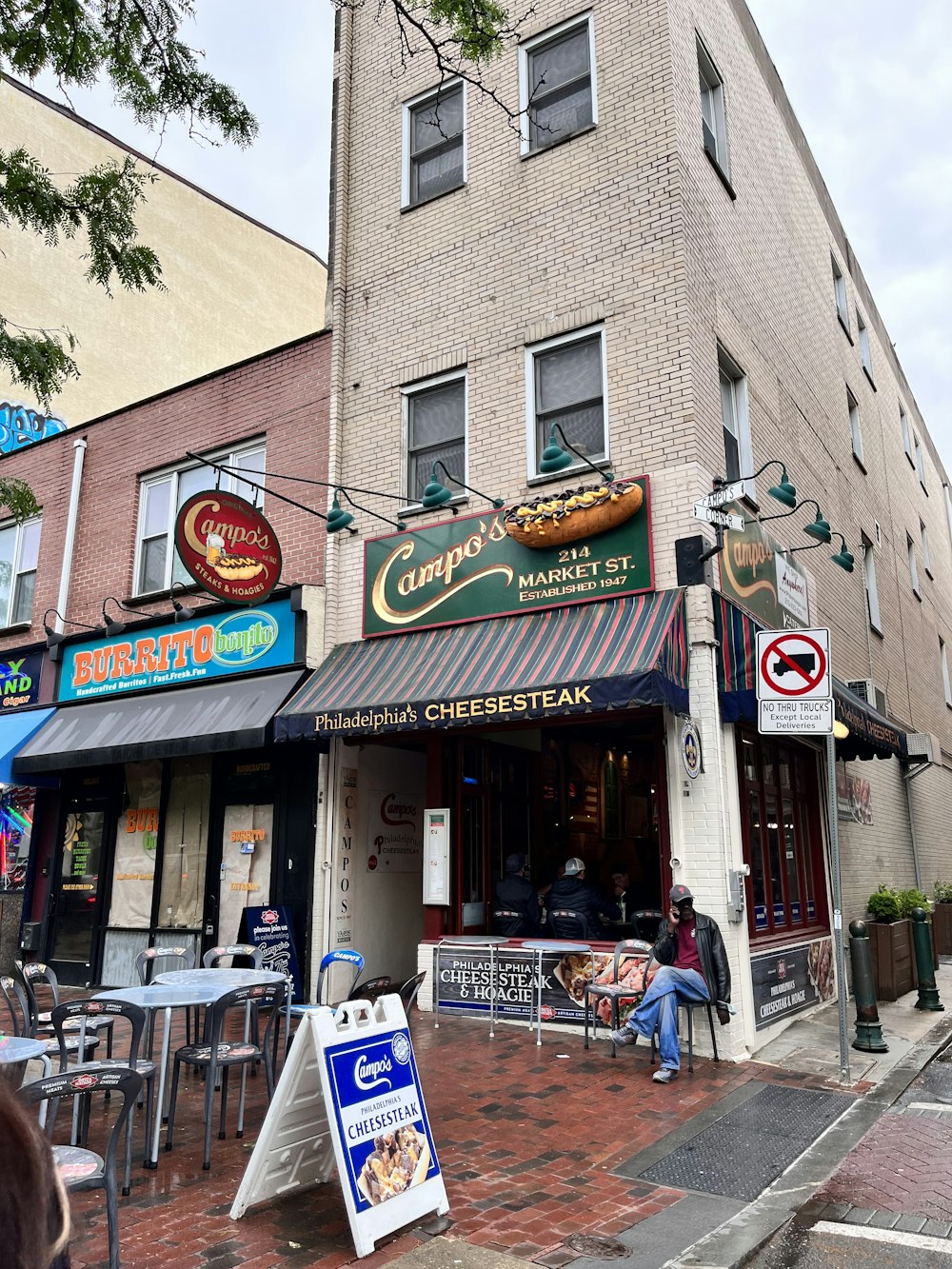 a person sitting outside a restaurant