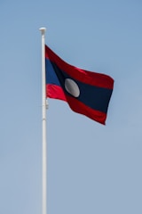 a red and white flag on a flagpole
