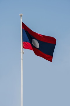 a red and white flag on a flagpole