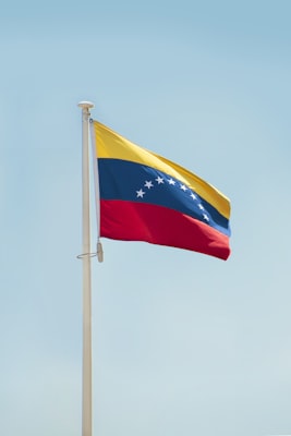 Venezuelan national flag mounted on a pole — photo by aboodi vesakaran on Unsplash