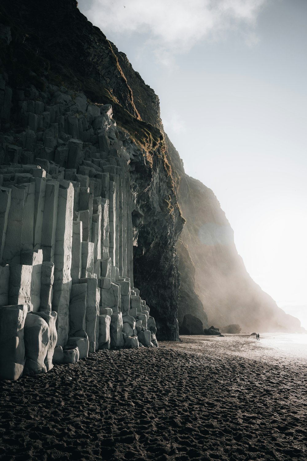 a stone building on a beach