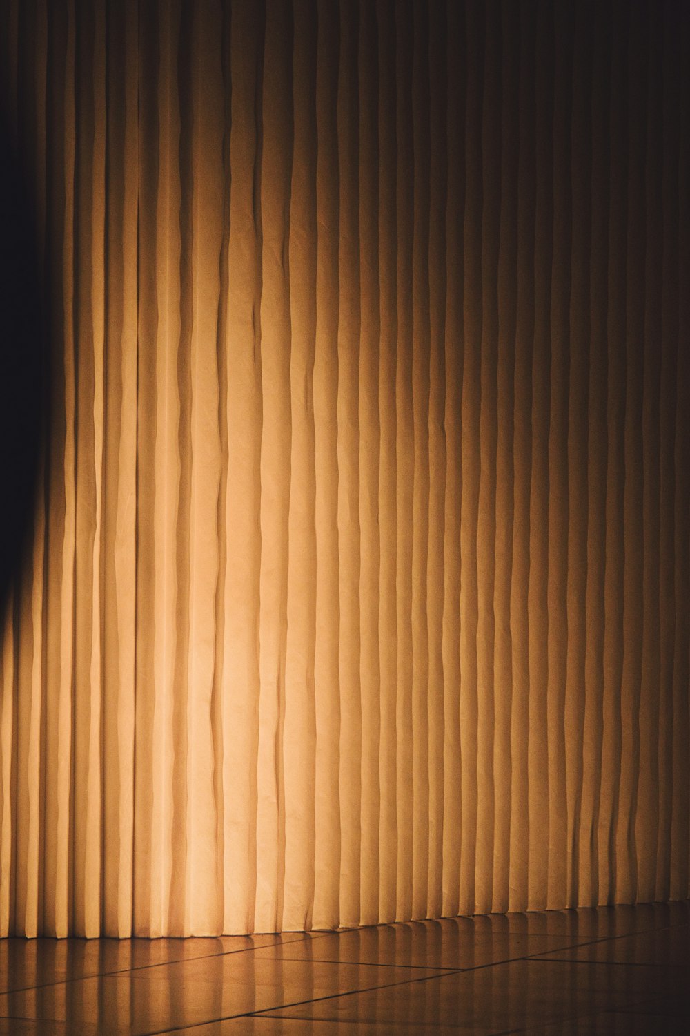 a brown curtain with a black background