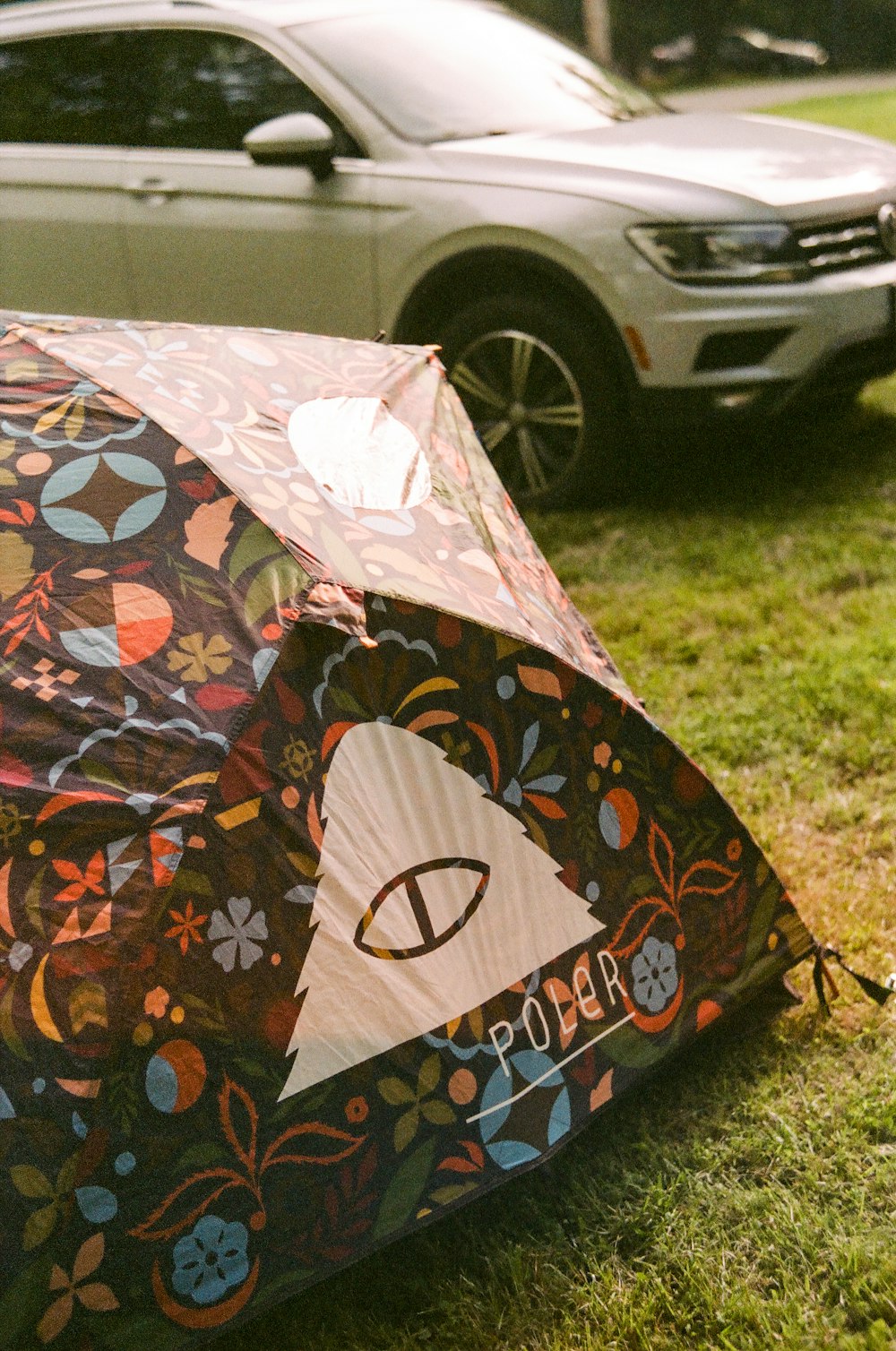 a colorful umbrella on the grass
