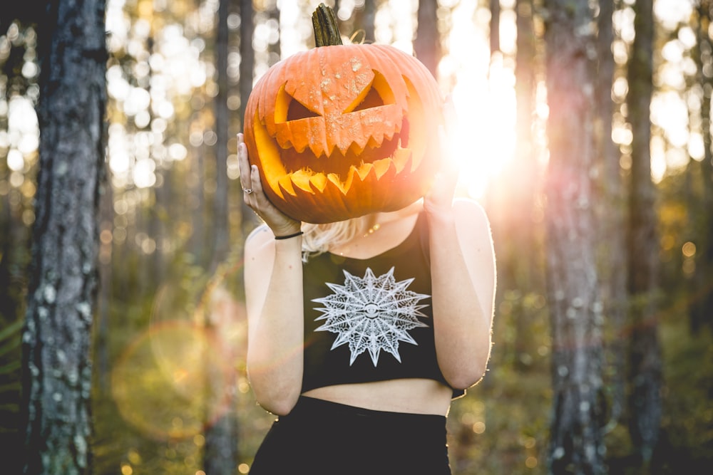 a woman holding a pumpkin