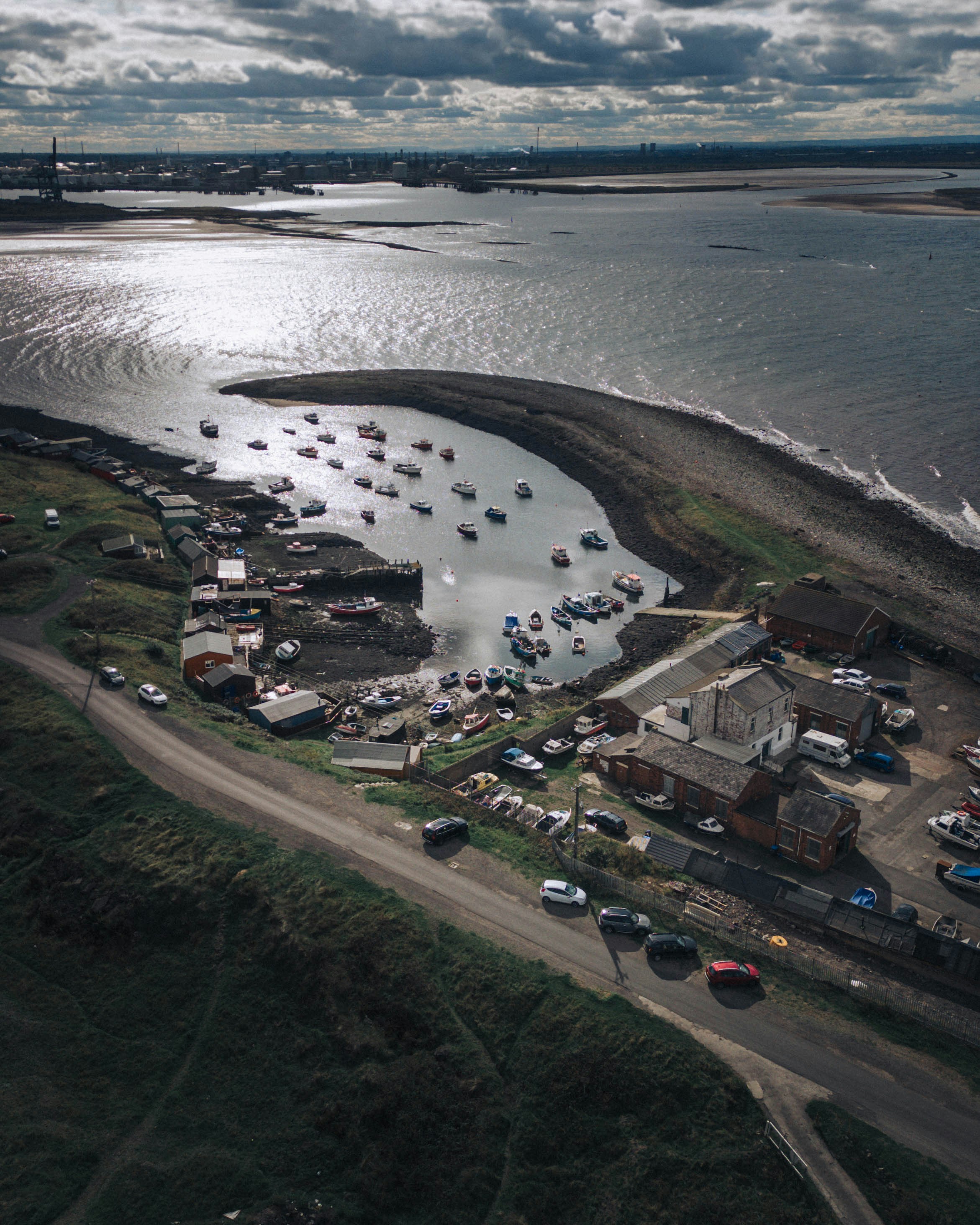 a body of water with a road and buildings along it