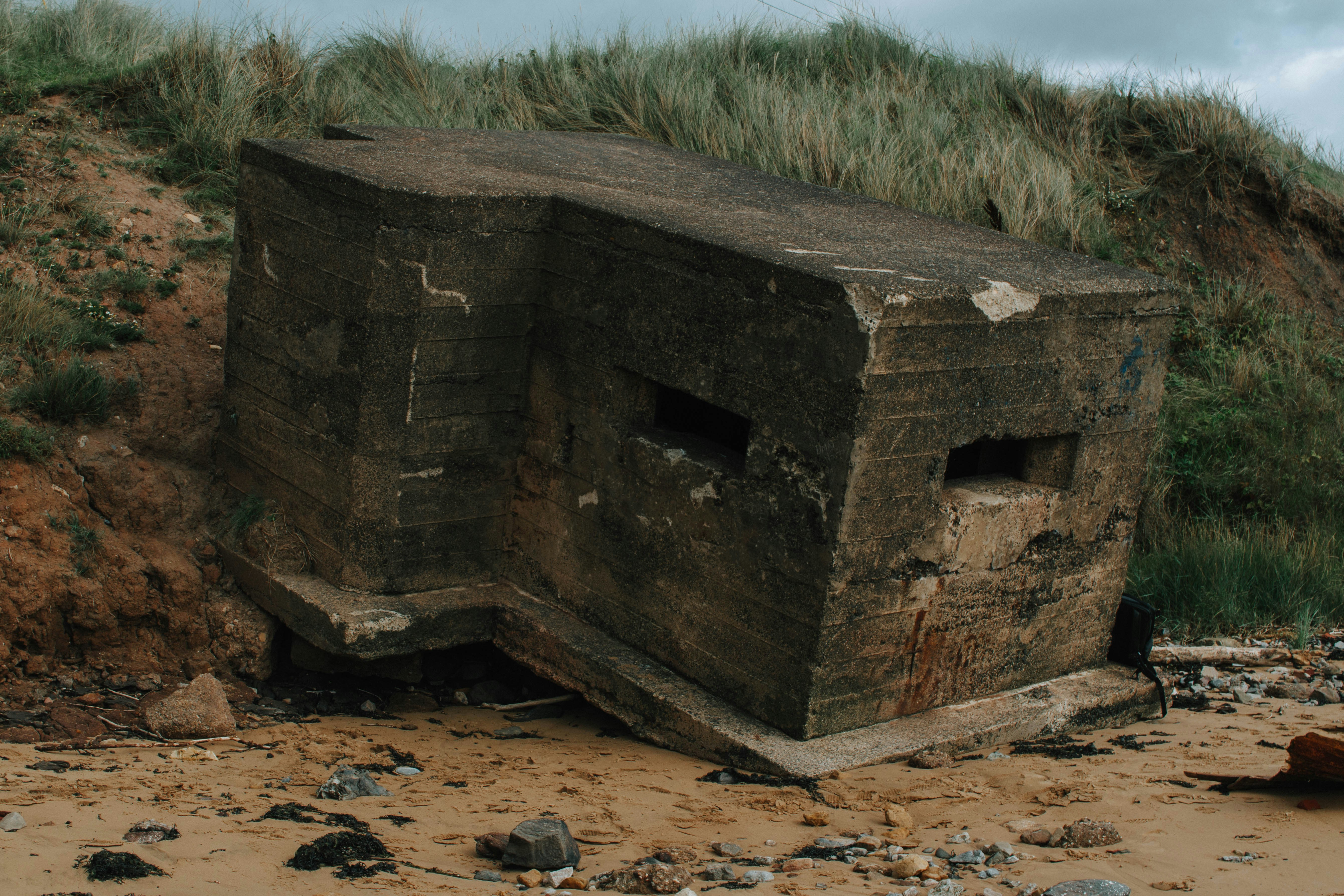 a stone structure in the dirt with Lalibela in the background
