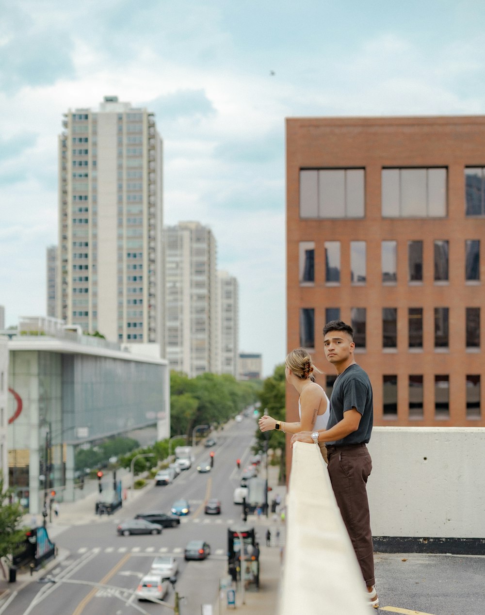 a man and woman posing for a picture on a rooftop