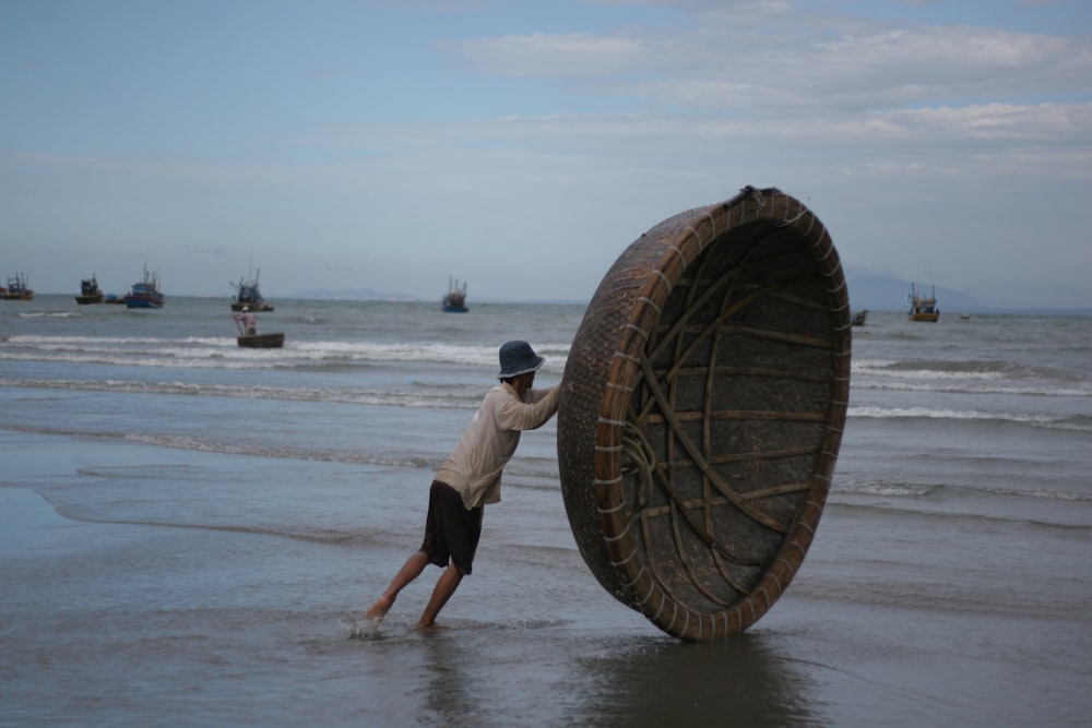a person carrying a large net on the beach