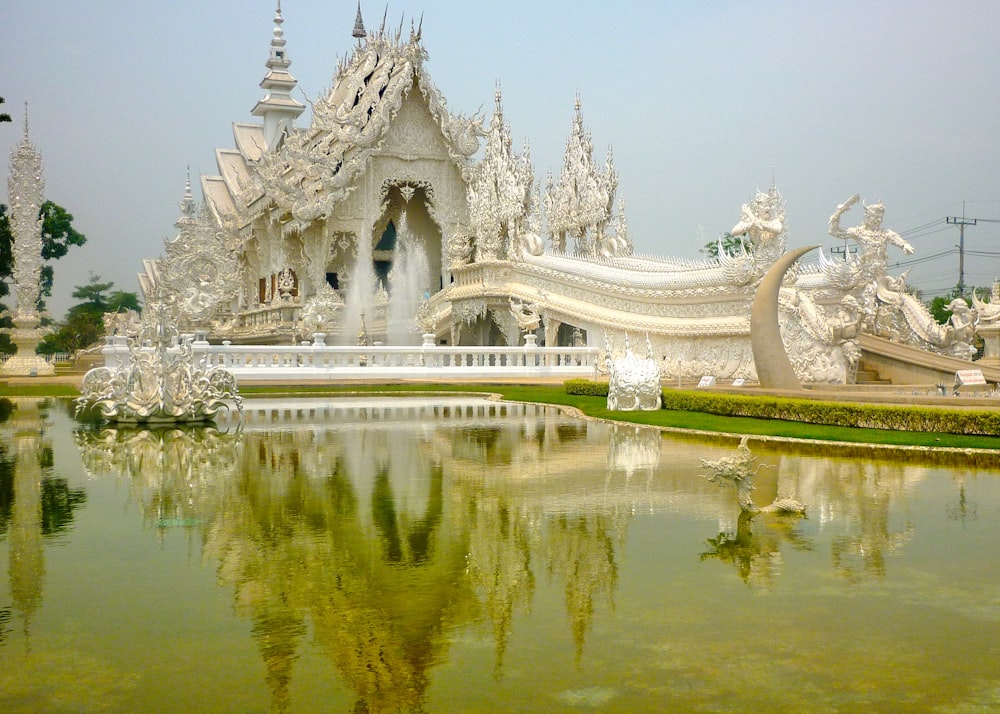 a fountain with water in front of a building with towers