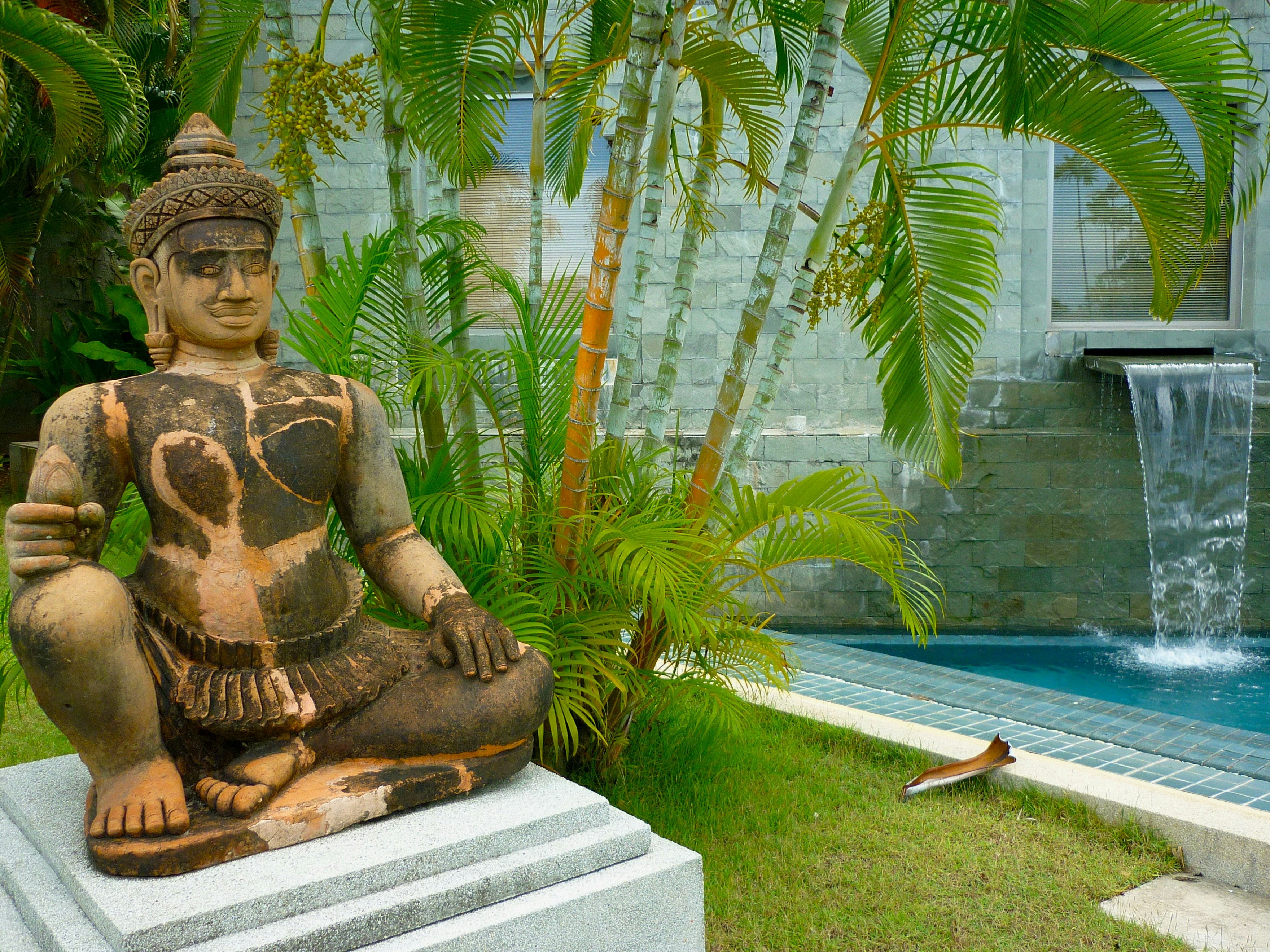 a statue of a person by a pool, 