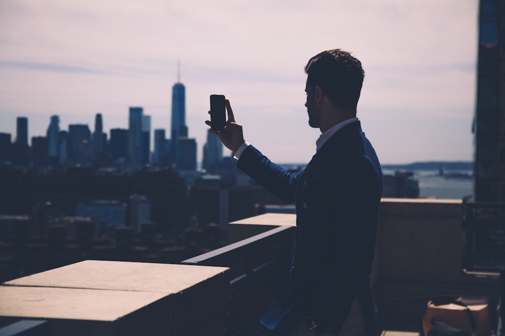 a man taking a picture of a city