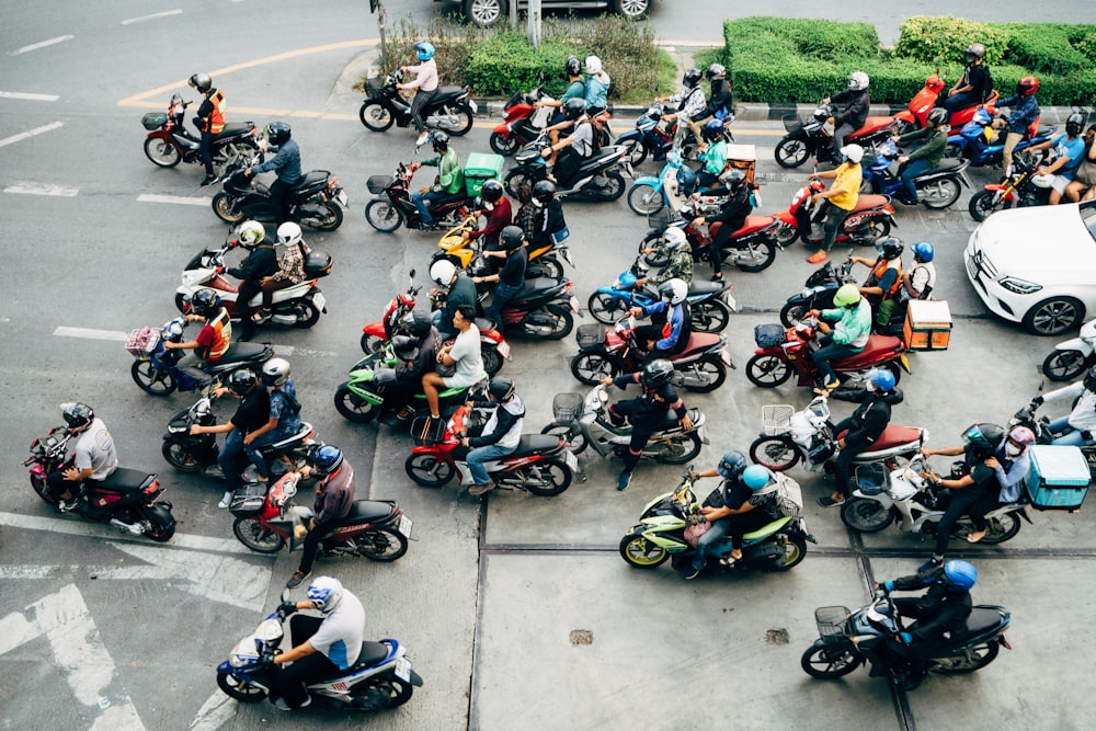 a group of motorcyclists are lined up on the road