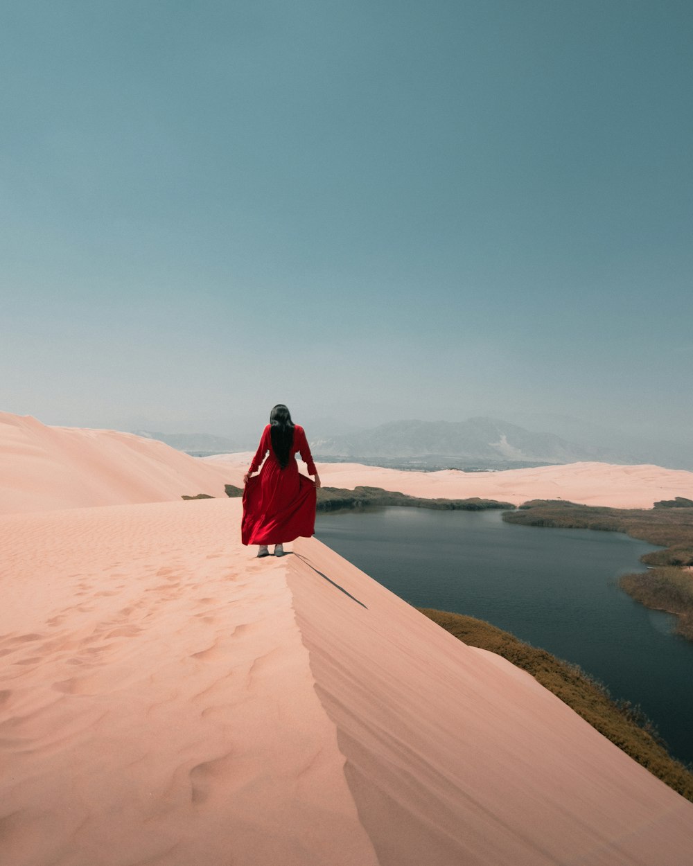 a person standing on a sandy hill