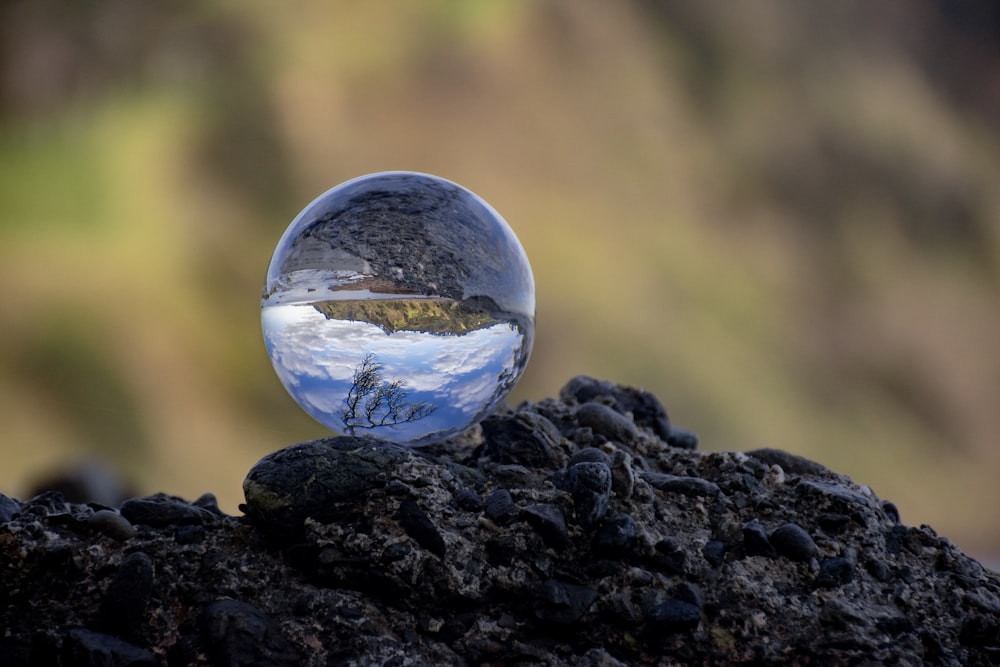 a glass sphere on a rock