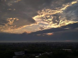 A dramatic travel film still showing a glowing city skyline with cinematic lighting and smooth drone motion.