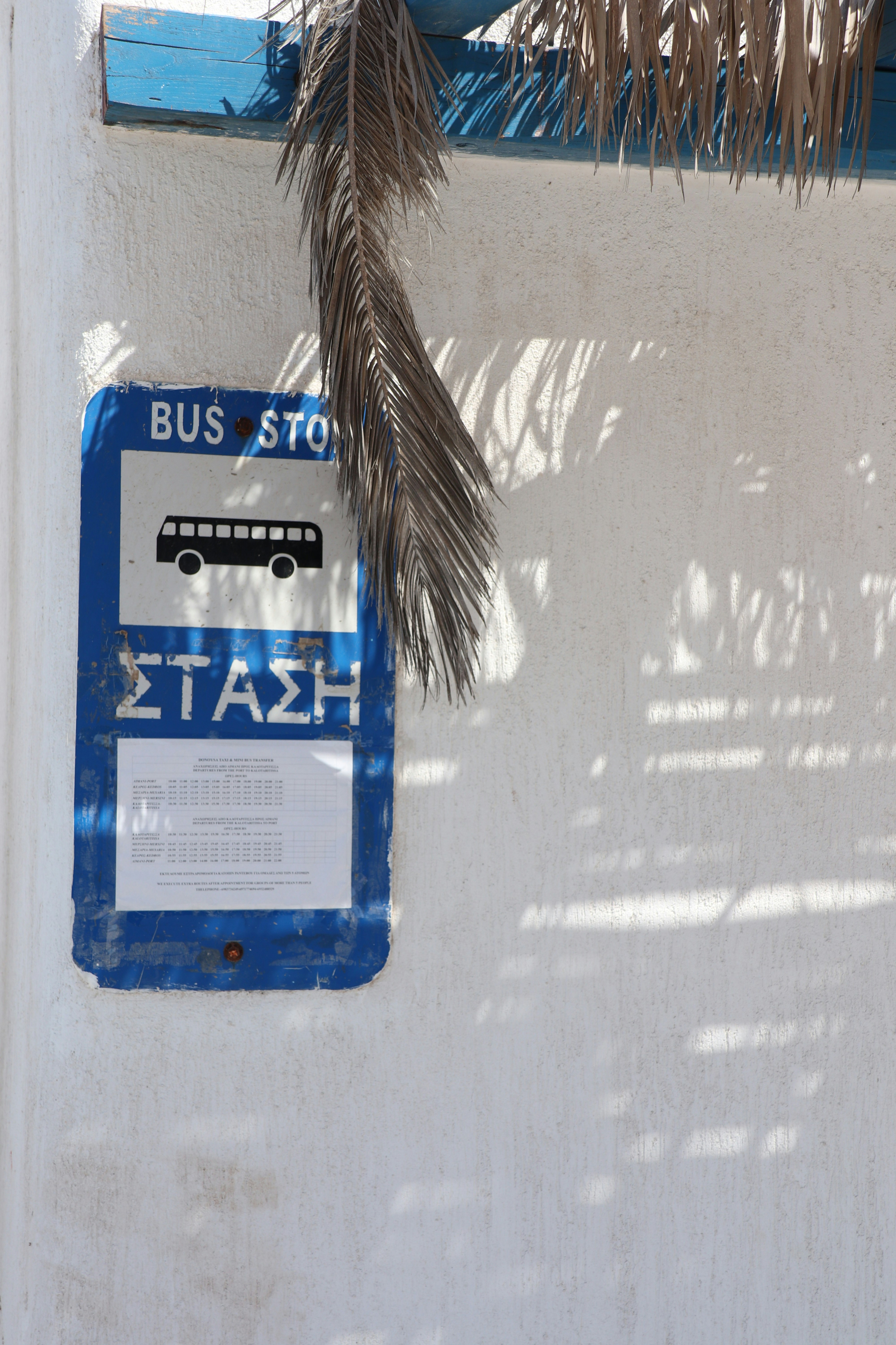 a blue and white sign on a window