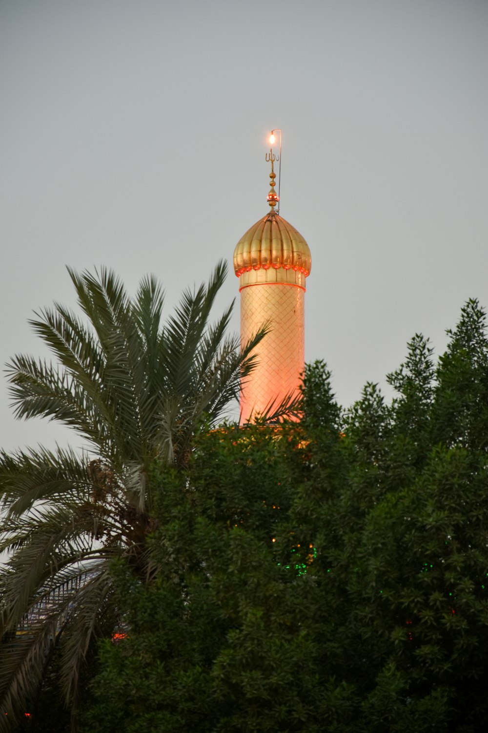 a tall tower with a gold top