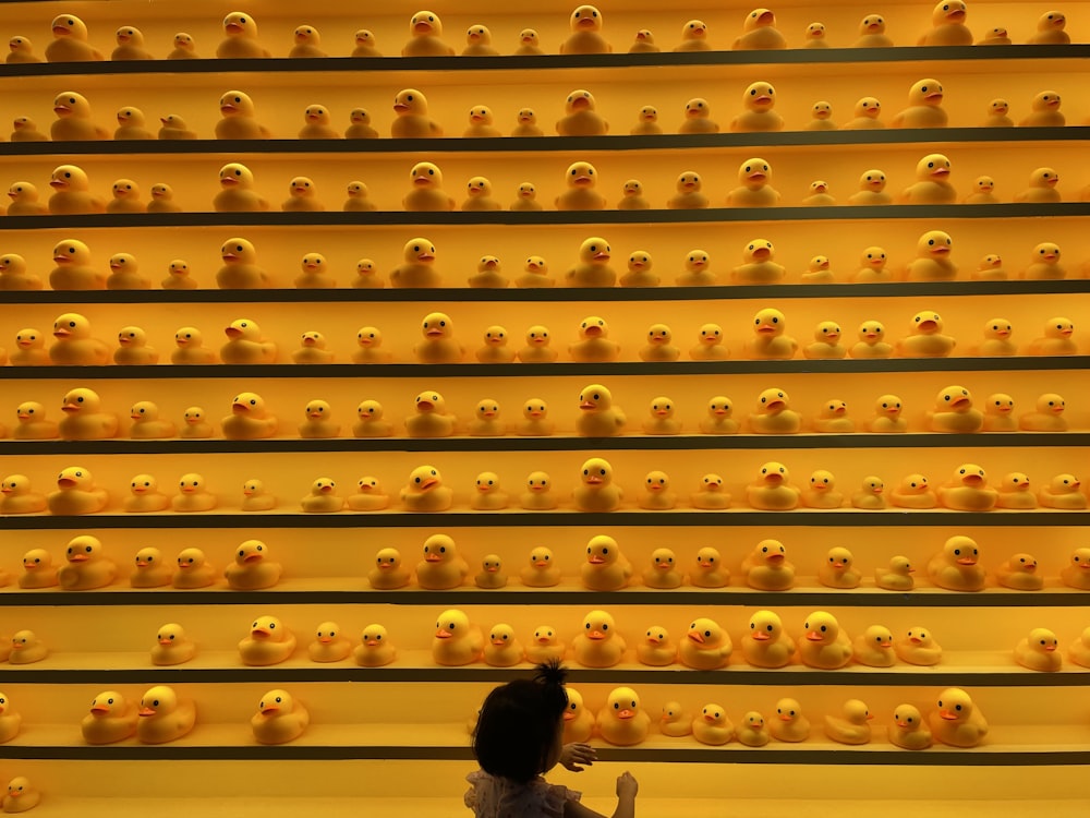 a person looking at a wall of shoes