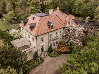 a large white house surrounded by trees