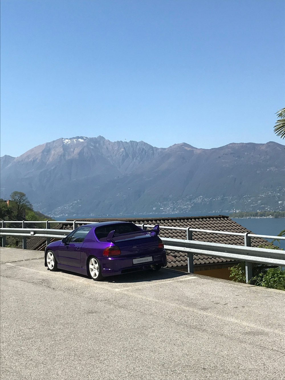 a car parked on a road by a body of water