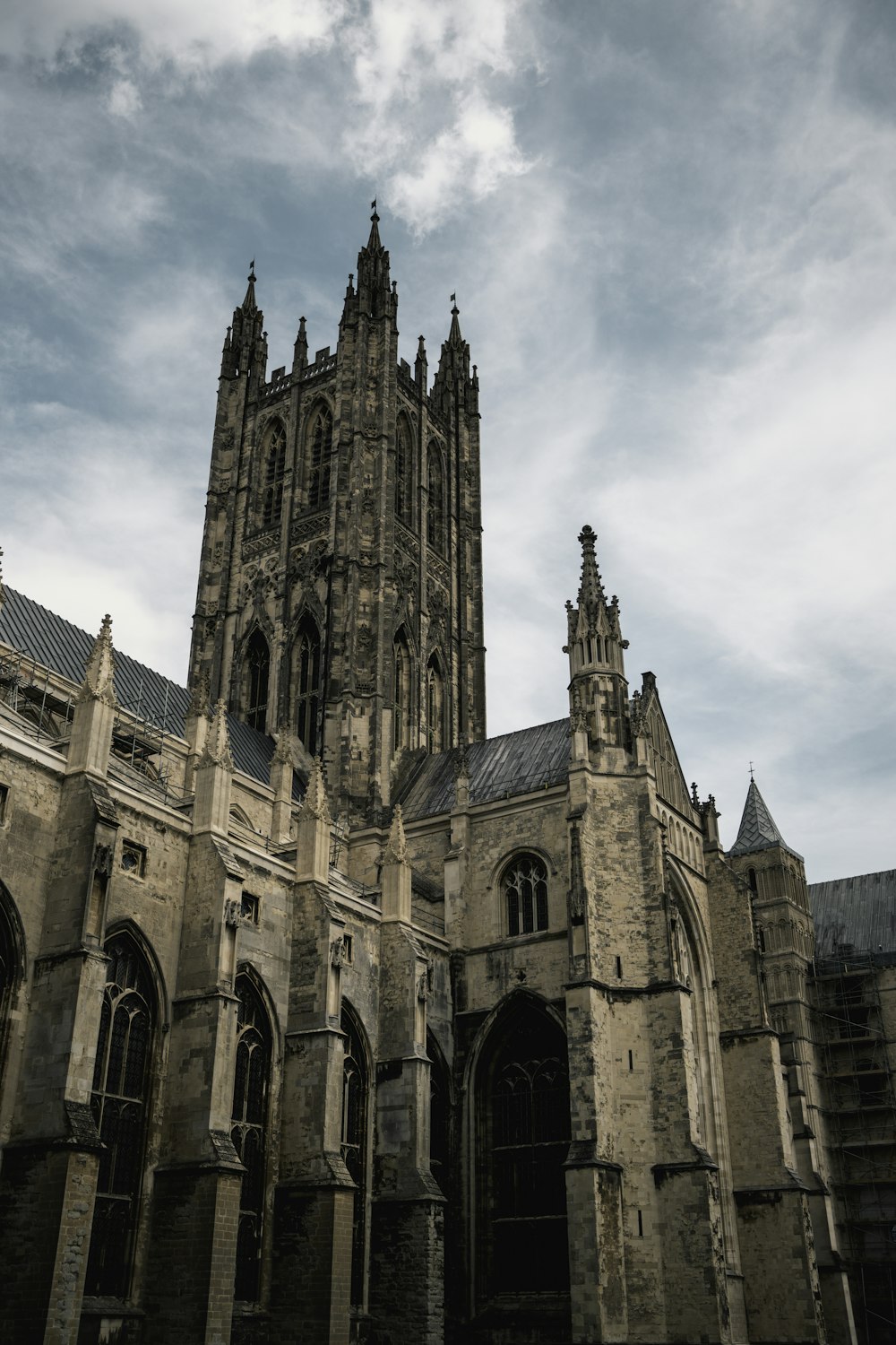 a large stone building with Canterbury Cathedral in the background