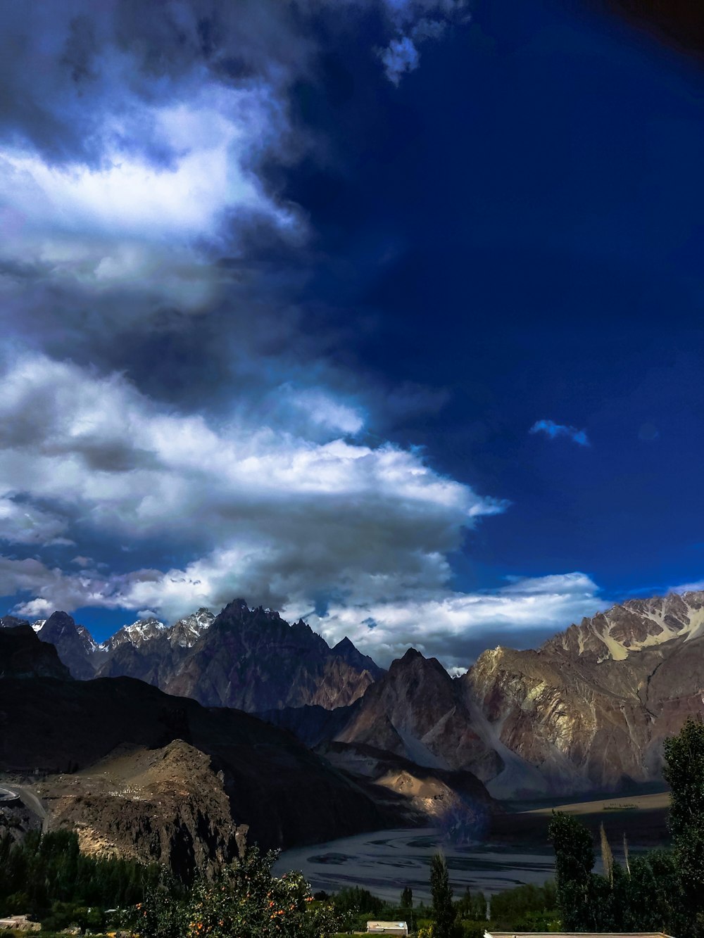 a river running through a valley between mountains