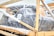 A large object wrapped in bubble wrap is secured within a wooden frame. There are some labels and markings on the packaging, with one label reading 'BURTON'. The object appears to be prepared for shipping or transport.