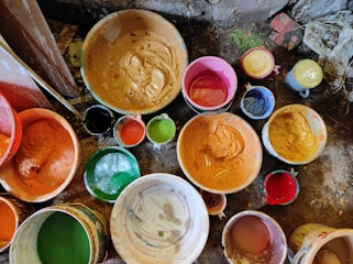 Painter mixing Italian paint colors in a workshop setting.