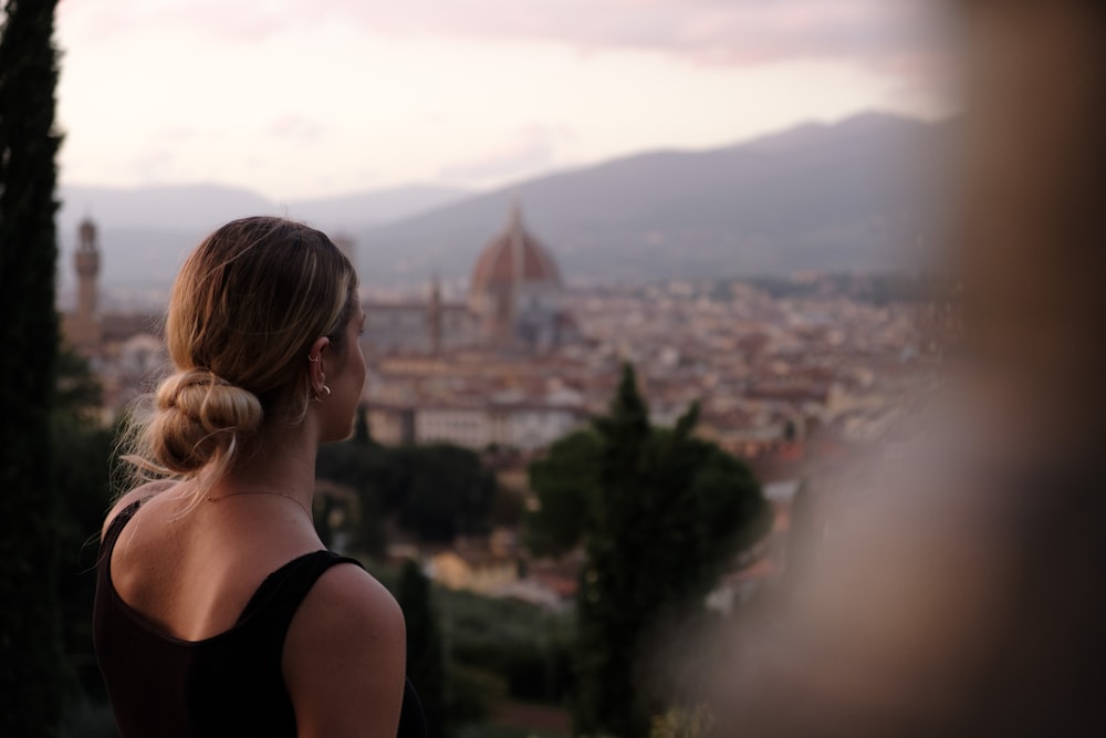 a woman looking out over a city