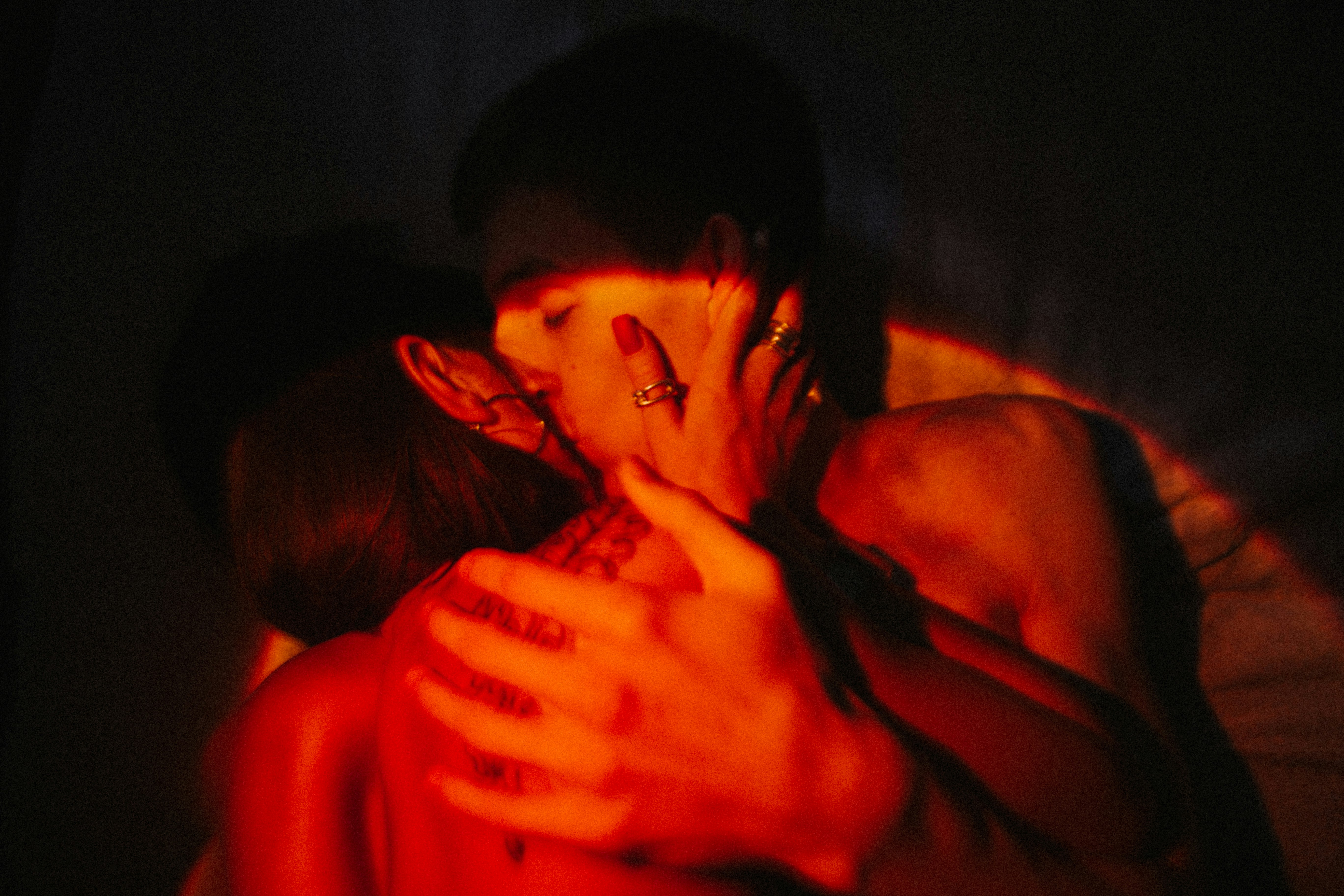 A couple in a passionate embrace, silhouetted against a warm light.