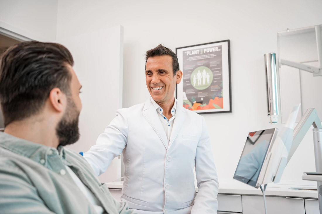 A dentist speaking with a patient in a modern dental office